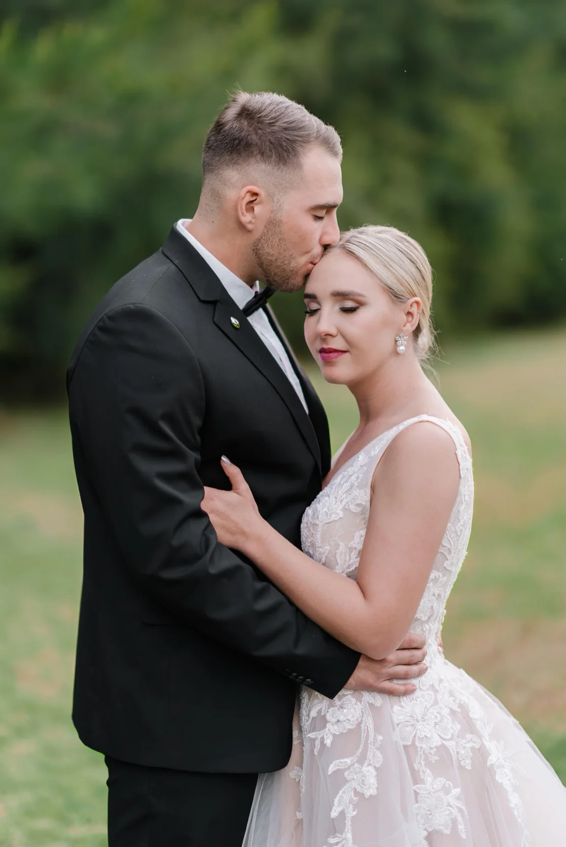 Groom kissing bride's cheek in the forest, Pretoria wedding